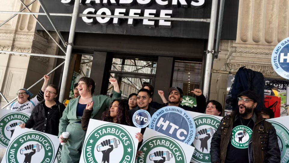 A gathering of Starbucks employees rallying outside of a location.